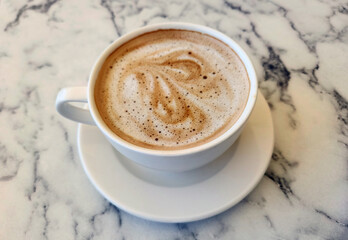 In a ceramic mug caffè latte, a coffee drink originated from Italy made with espresso and steamed milk.