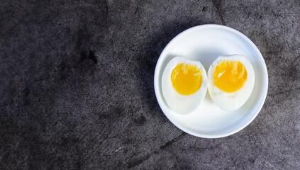 Halved Boiled Eggs on Plate - Top View with Copy Space