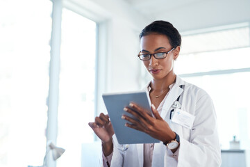Doctor, hospital and woman reading on tablet for research, information and healthcare update. Digital technology, medical professional and check schedule, report or results for telehealth on internet