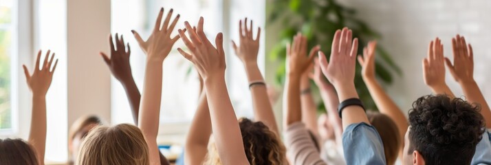 A group of people enthusiastically raise their hands in a vibrant, engaging classroom environment filled with natural light and greenery.
