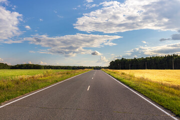 A long road with a clear blue sky above it