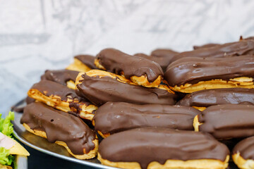 Chocolate-glazed eclair cakes on a plate.