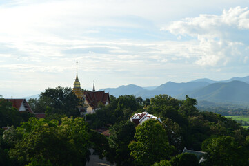Fototapeta premium Golden pagoda Lanna Architecture , Symbols of Buddhism, South East Asia and Beautiful Sunset Sky and Landscape at Wat Phra That Doi Saket temple Chiang Mai ,Northern Thailand