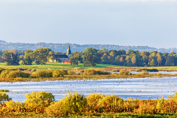 Country church by a lake in a scenic landscape