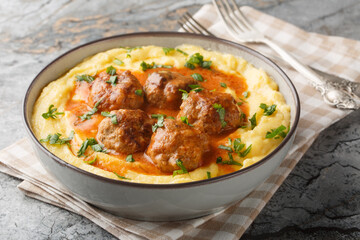 Classic Italian meatballs with creamy polenta closeup on the bowl on the table. Horizontal