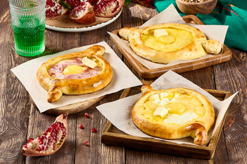 Delicious Adjarian Khachapuri Variations with Bacon, Four Cheeses, and Classic Flavors on Rustic Wooden Table
