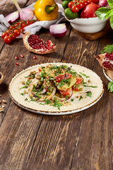 Traditional Georgian Salad with Tomatoes, Cucumbers, and Nuts on Rustic Wooden Table