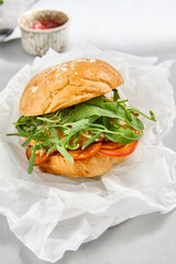 Delicious Arugula and Shrimp Burger on a Soft Bun - Gourmet Seafood Sandwich Stock Photo