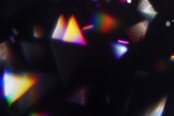 Prism light reflections on black background. Blurred geometric shapes, soft gradients, ethereal visual overlay effect. Glowing colorful lights and bokeh lens flare, refraction of sunlight prism effect