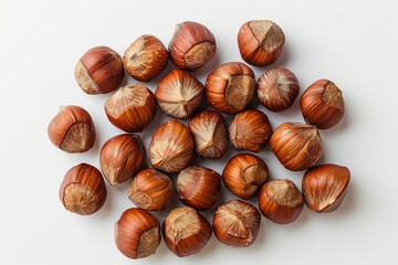 Obraz premium A collection of hazelnuts arranged on a white background.