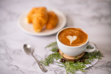 coffee heart pattern with croissant