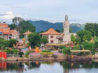 Statue of goddess Guanyin at Bodhisattva Viharn view from Bridge over the River Kwai, Kanchanaburi Province, Thailand.