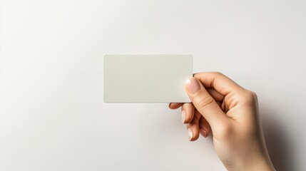 Hand displaying a credit card, business card, or voucher against a white background, ideal for use as a template or mock-up