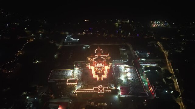 Aerial night shot of Ayodhya Ram Temple, a glowing temple complex, shining brightly amidst a dark cityscape. Famous historical place in India
