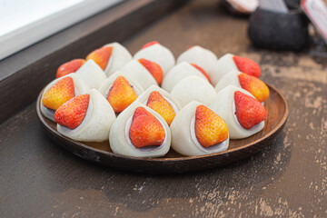 A plate of strawberries mochi.