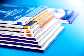 Stack of books on blue background. Back to school and education concept.