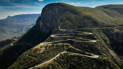 Winding Serra da Leba Road in Angola surrounded by lush mountains under a clear sky