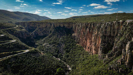 Serra da Leba Road showcases dramatic cliffs and lush landscapes in Angola during daylight