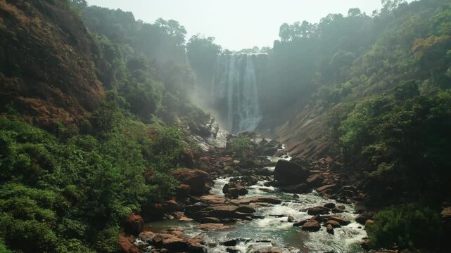 Aerial view of a waterfall surrounded by trees in a natural landscape. Falling water from 150 feet large rock hitting the rock surface looks beautiful. Tarabu waterfall Andhra Pradesh, India