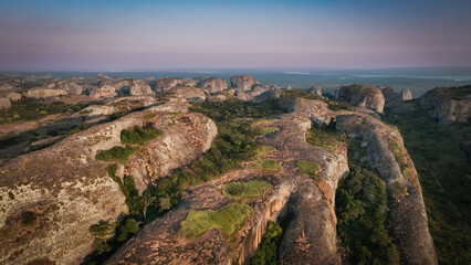 Panoramic view of Pedras Negras Mountains in Angola showcasing unique rock formations and lush...