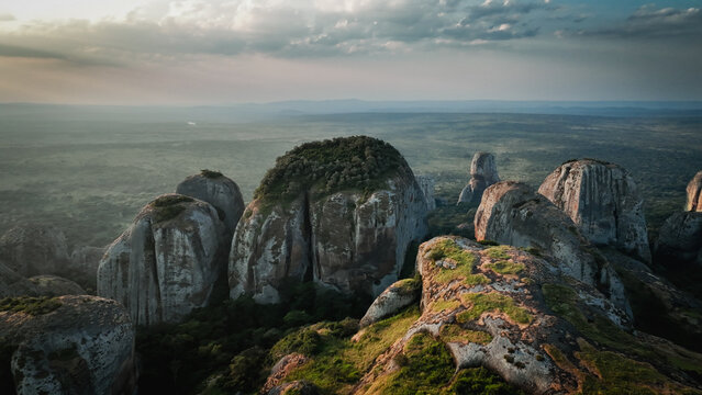 Majestic Pedras Negras Mountains in Angola during golden hour with dramatic rock formations and lush greenery
