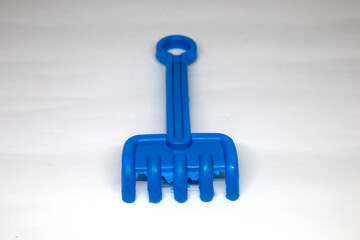 blue toy sand shovel isolated on white background