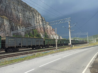 Freight train in the mountains in summer