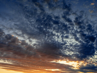 Cloudy blue dramatic sunset sky. Nature background for design and replacement. Warm and cold color tone