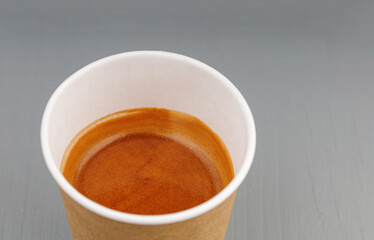 top view cardboard cup with coffee, espresso, americano on gray wooden background
