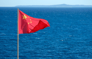 Chinese national flag at the coast near the sea
