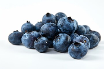 A pile of fresh blueberries on a white background, showcasing their vibrant color and texture.