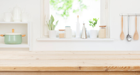 Empty wood table top counter and blur kitchen window interior background ready for product montage