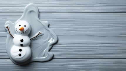 A melting snowman figurine on wood