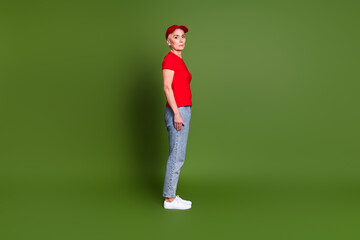 Full body photo of attractive mature woman professional delivery employee profile wear red uniform workwear isolated on khaki background