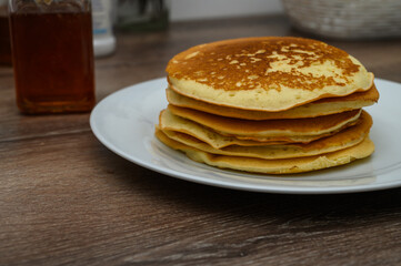 Delicious breakfast with pancakes on a wooden table