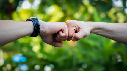 Deal of teamwork with the Man hand a fist bump commit as get together in the office.