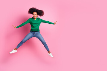 Full size photo of pretty young girl jump have fun wear trendy green outfit isolated on pink color...