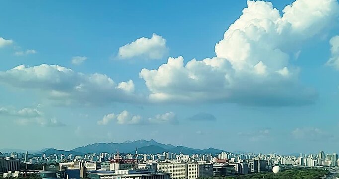 cloudscape with a cityscape of Yeouido, Seoul, Korea, a timelapse of a beautiful blue sky with white clouds during sunset, for the background