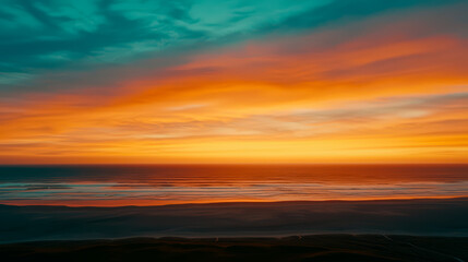 Fototapeta premium Stunning sunset over the ocean with vibrant colors illuminating the sky, creating a serene and picturesque landscape.