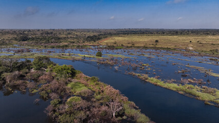 Aerial view of the wild landscape in Angola showcasing rivers and lush vegetation under a clear sky