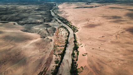 Aerial view of the diverse wild landscape of Angola showcasing arid terrain and winding river