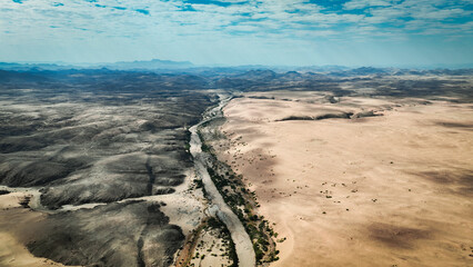 Aerial view of Angola's wild landscape showcasing contrasting terrains and river systems under a...