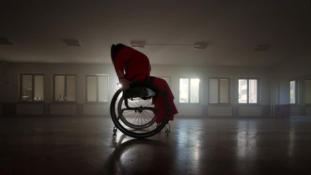 Fantastic and inspiring wheelchair para dance of a woman, a dancer with a physical disability moving with agility around the ballroom, wide shot.