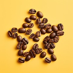 Artistic arrangement of coffee beans forming a star shape on a vibrant yellow background, perfect for coffee-related projects.