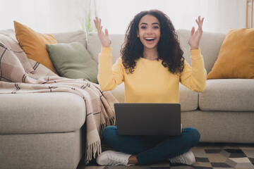 Photo portrait of wavy hair young girl sitting at home using her laptop raised hands up enjoying...