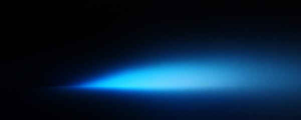 Fototapeta premium Abstract blue spotlight on a black background banner with empty space for text.