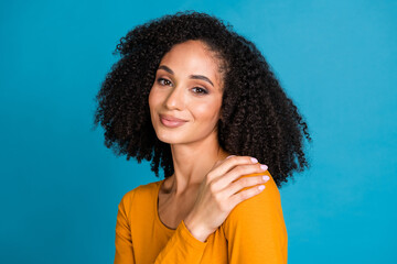 Fototapeta premium Photo portrait of pretty young girl cuddle self comfortable wear trendy yellow outfit isolated on blue color background