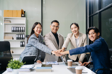 Young people professional colleagues are stretching arms showing team spirit focus on hands.