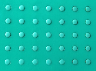 Round circles arranged in a grid pattern on a green background abstract texture