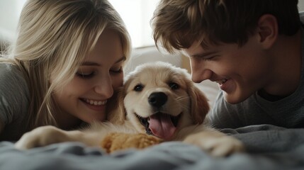 Naklejka na ściany i meble A happy couple enjoys quality time with their golden retriever puppy. The warmth and joy of this moment are captured perfectly in a soft and cozy home setting. 